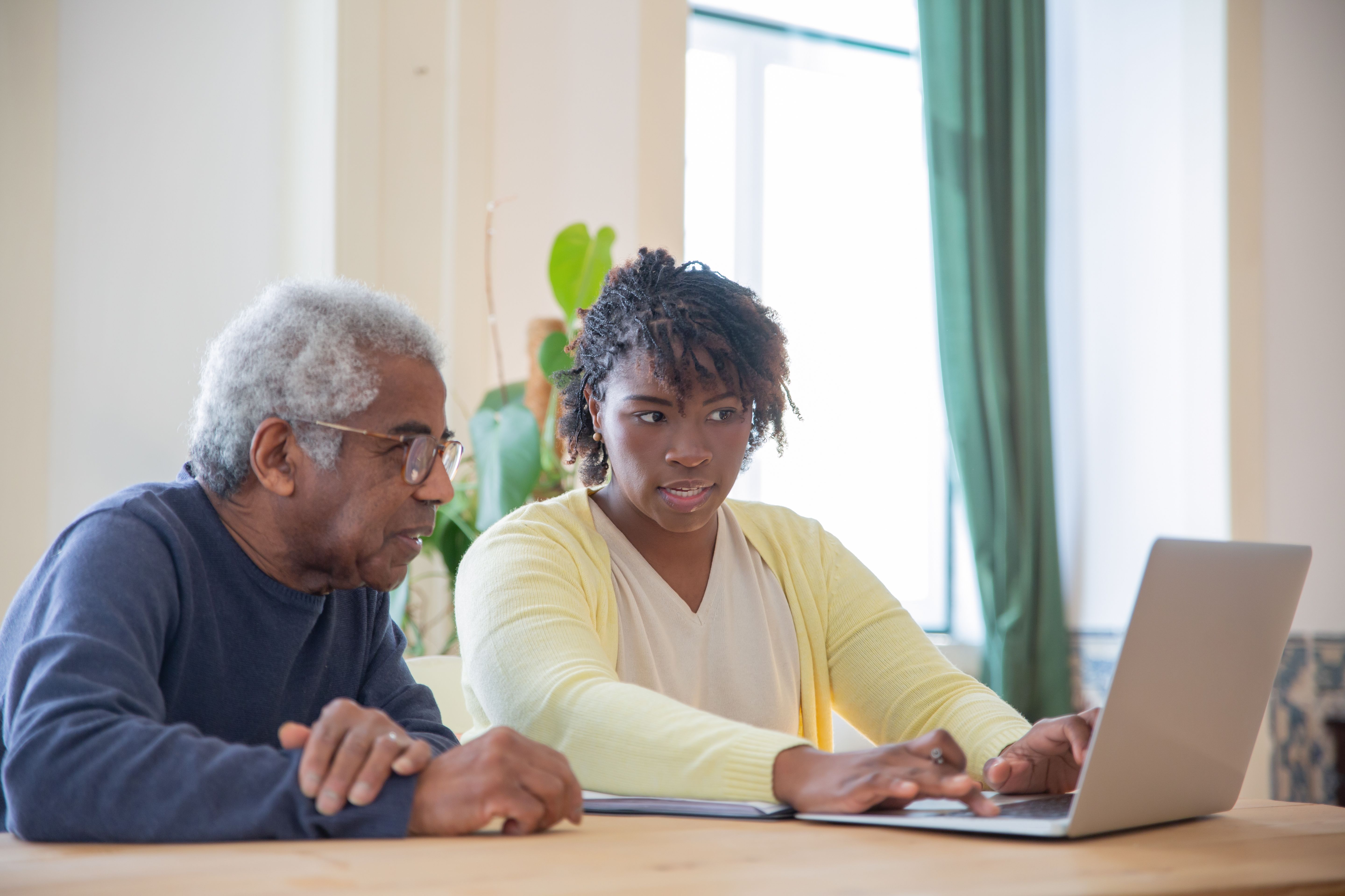 Caregiver helping senior man with Medicaid options